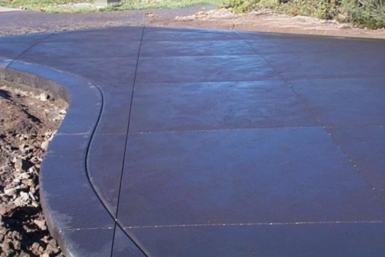 Black coloured driveway with saw cuts
