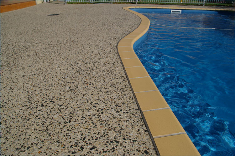 Rear yard concrete pebble design including pool integration. 