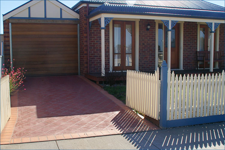 Residential property driveway using stencile technique to create a brick looking driveway.