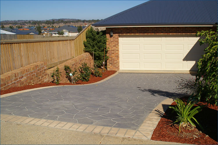 Residential photo of driveway stencile concrete techinque to create the look a stone driveway.
